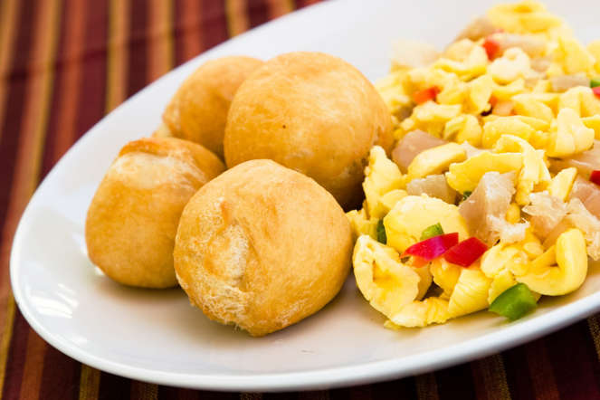 National dish for the Jamaicans, it is prepared with saltfish, boiled ackee, onions and tomatoes sautéed together. It is usually served with vegetable dumplings, fried plantains or rice.