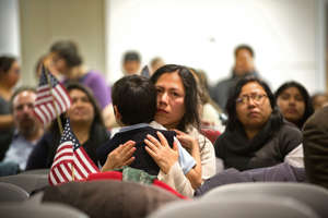 Martha Moran, with her six-year-old son Tonatiuh Moran, listen during a viewing party for U.S. President Barack Obama's speech on executive action immigration policy reform at the offices of 32BJ SEIU, a workers union, on November 20, 2014 in New York City.
