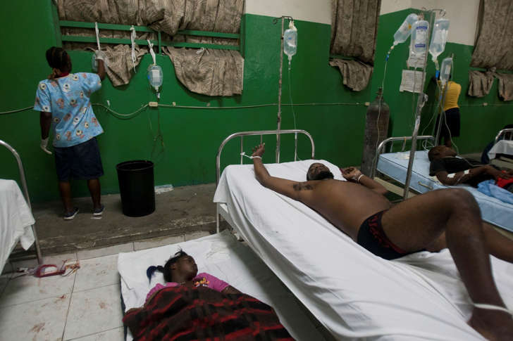 People injured during carnival celebrations lie down as they wait for treatment at the emergency room of the General Hospital in Port-au-Prince, Haiti, early Tuesday, Feb. 17, 2015. At least 18 people on a music group's packed Carnival float in the Haitian capital were killed Tuesday when they were electrocuted by a power line, officials said. The accident occurred as thousands of people filled the streets of downtown Port-au-Prince for the raucous annual celebration.