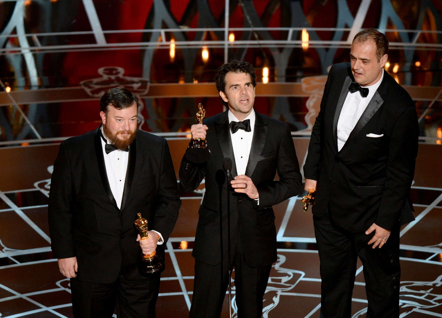 Winners for Best Sound Mixing "Whiplash" Craig Mann, Ben Wilkins and Thomas Curley give their acceptance speech on stage at the 87th Oscars February 22, 2015 in Hollywood, California. AFP PHOTO / Robyn BECK        (Photo credit should read ROBYN BECK/AFP/Getty Images)