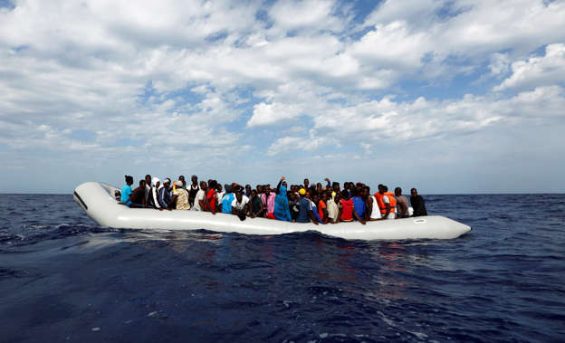 A rubber dinghy with 104 sub-Saharan Africans on board is seen some 25 miles off the Libyan coast.