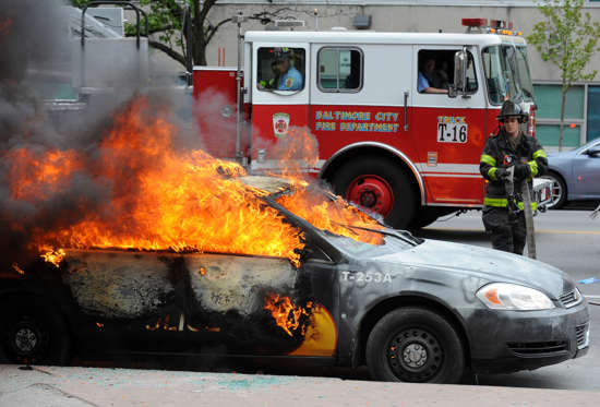 A Maryland Transit Authority patrol car burns at North and Pennsylvania Avenues on Monday, April 27, 2015, in Baltimore.