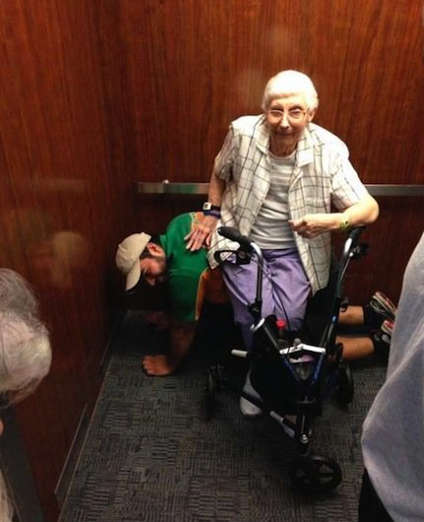 A college student gets on his hands and knees to serve as a human bench for an elderly woman.