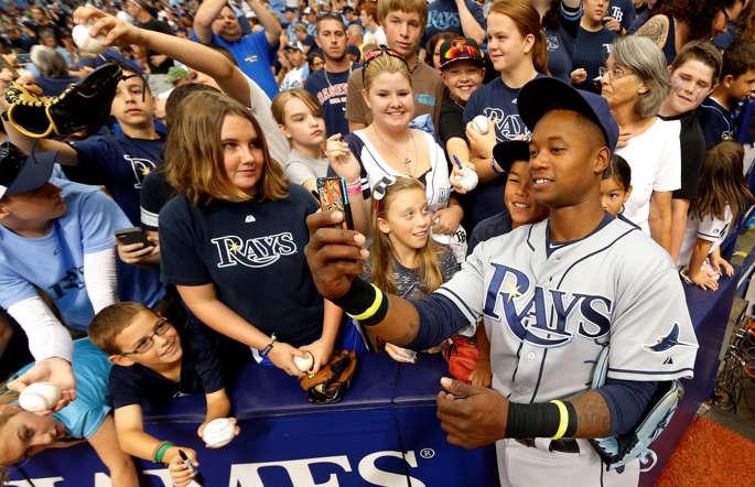 The Tampa Bay Rays' Tim Beckham uses a fan's phone to take a selfie with him before the game against the Baltimore Orioles on May 3 in St. Petersburg, Fla.