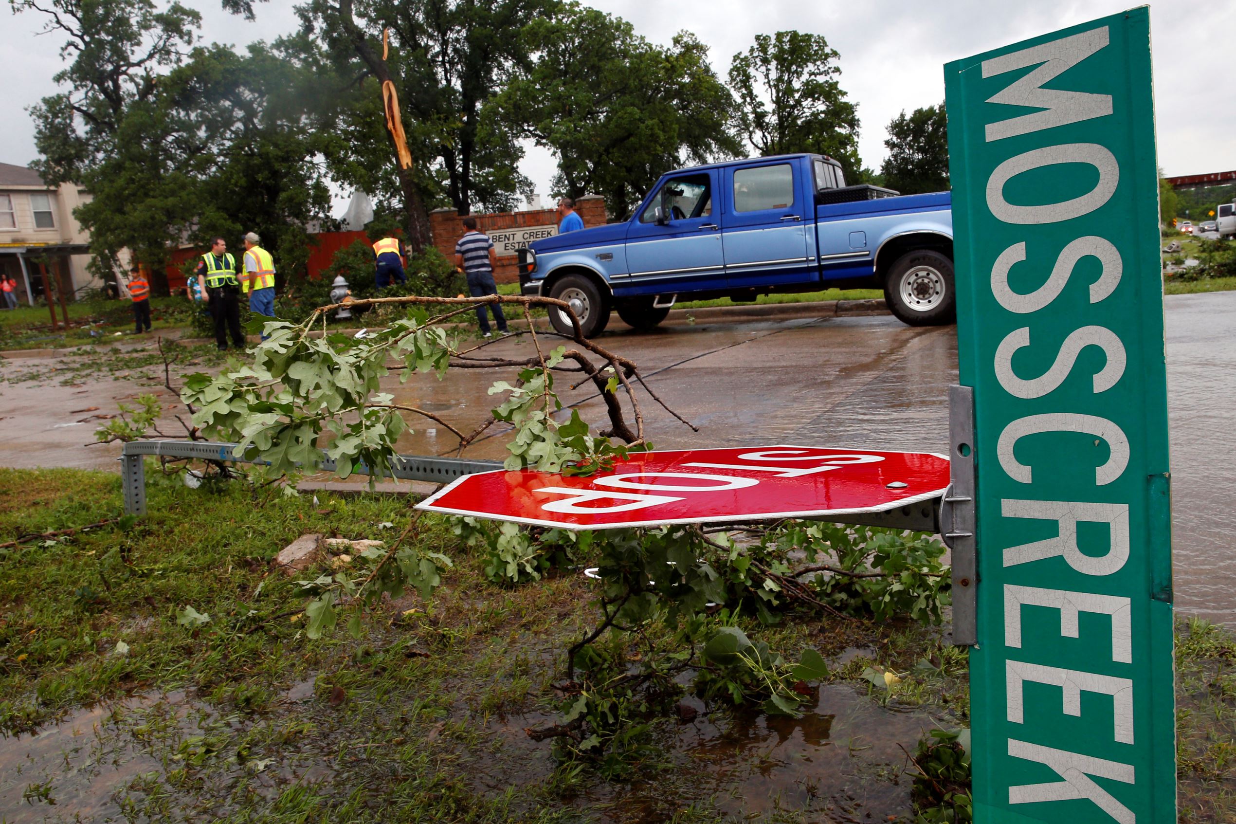 A street sign at the intersection of Hwy 377 and Mosscreek Drive lies on the ground after a possible tornado touched down in the Bent Creek Estates neighborhood in Denton, Texas, on Sunday, May 10, 2015. (Richard W. Rodriguez/Fort Worth Star-Telegram/TNS via Getty Images)