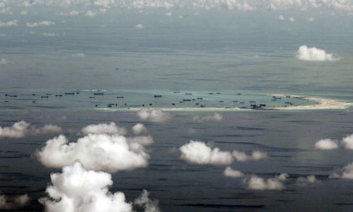 An aerial photo taken though a glass window of a Philippine military plane shows the alleged on-going land reclamation by China on mischief reef in the Spratly Islands in the South China Sea, west of Palawan, Philippines, May 11, 2015.