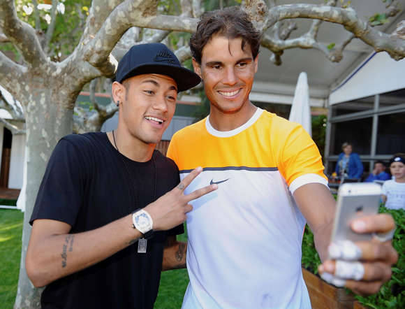 Rafael Nadal (right) of Spain takes a selfie with soccer player Neymar of Barcelona during day three of the Barcelona Open Banc Sabadell at the Real Club de Tenis Barcelona on April 22, 2015, in Barcelona, Spain.