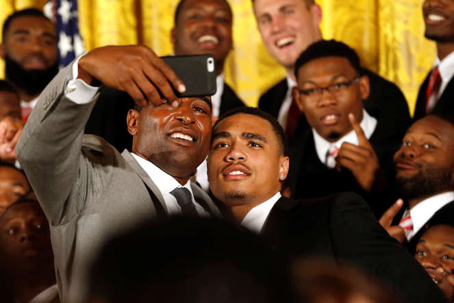 NFL Hall of Famer and former Ohio State Buckeyes player Cris Carter (left) takes a selfie with Buckeyes wide receiver Jalin Marshall after a ceremony to honor the team for winning the national championship on April 20, 2015, in the East Room of the White House.