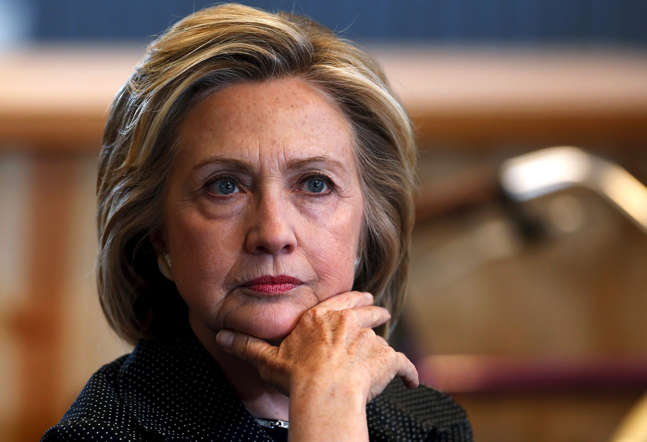 U.S. presidential candidate Hillary Clinton listens to remarks at a roundtable campaign event with small businesses in Cedar Falls, Iowa, United States, May 19, 2015.    REUTERS/Jim Young   - RTX1DNY9