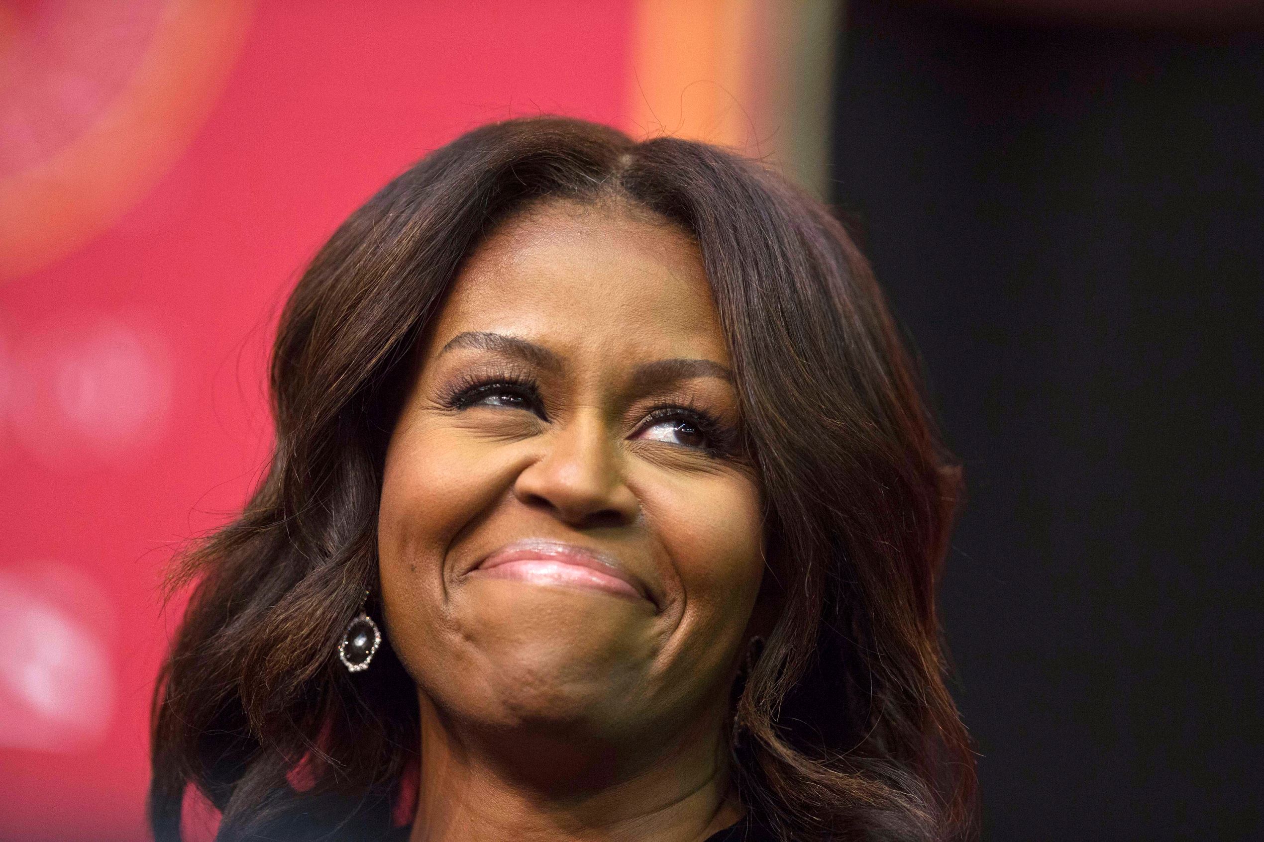 First lady Michelle Obama smiles towards the crowd before she speaks during the Tuskegee University's spring commencement, Saturday, May 9, 2015, in Tuskegee, Ala. (AP Photo/Brynn Anderson)