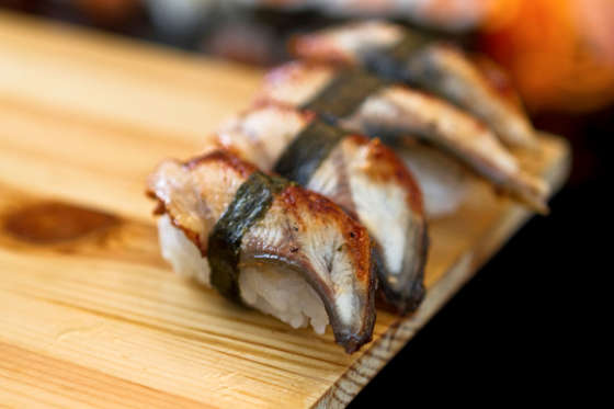 eel sushi on wooden tray