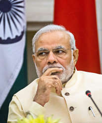 File: Narendra Modi, India's prime minister watches Xi Jinping, China's president, during a meeting to sign a series of agreements between the two nations at Hyderabad House in New Delhi, India, on Thursday, Sept. 18, 2014.