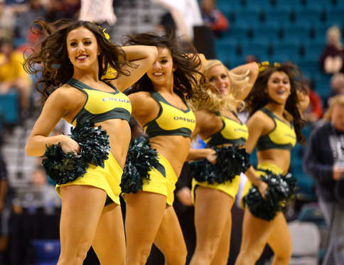 Oregon Ducks cheerleaders perform during a first-round game of the Pac-12 Basketball Tournament against the Oregon State Beavers at the MGM Grand Garden Arena on March 12, 2014 in Las Vegas, Nevada.