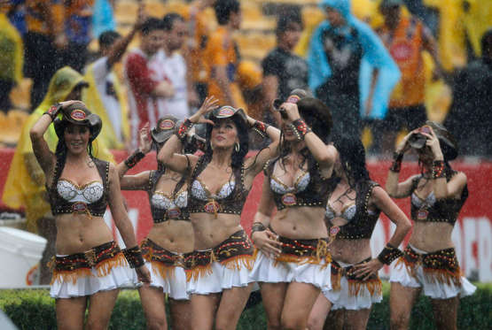 Cheerleaders perform under heavy rain before the Mexican league championship soccer match between the Tigres and Guadalajara Chivas at the Universitario stadium in Monterrey September 25, 2010.