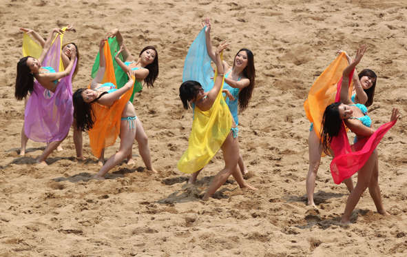Cheerleaders dance during the Men's Beach Soccer Preliminary match between China and Afghanistan on Day 0 of the 3rd Asian Beach Games Haiyang 2012 at Fengxiang Beach on June 16, 2012 in Haiyang, China