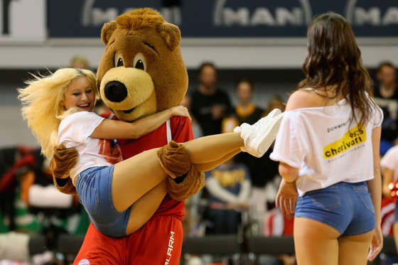 Mascot Bernie  of Muenchen jokes with a cheerleader during the Beko Basketball Bundesliga match between FC Bayern Muenchen and WALTER Tigers Tuebingen at Audi-Dome on November 2, 2014 in Munich, Germany.