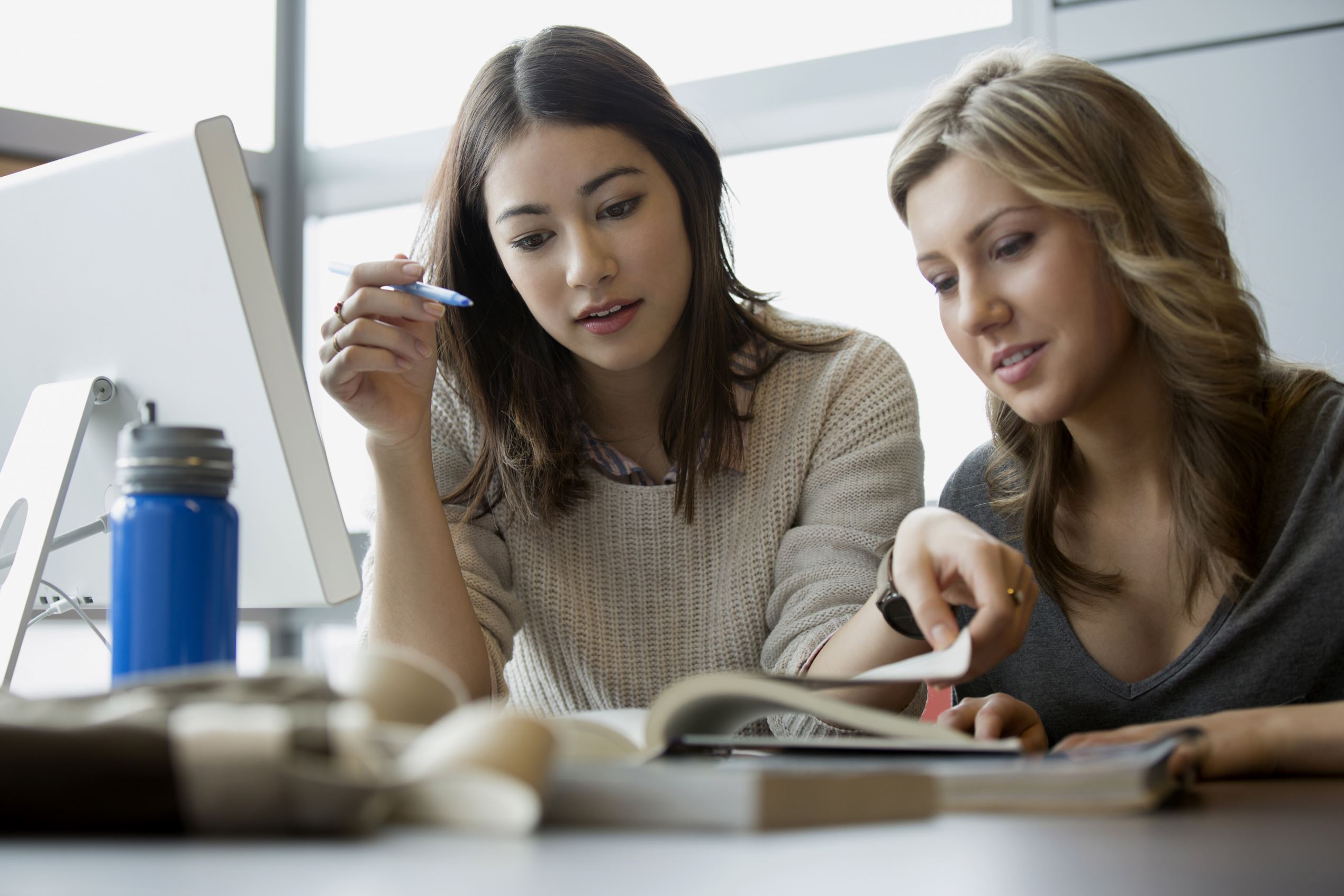 Millennials studying at a table.