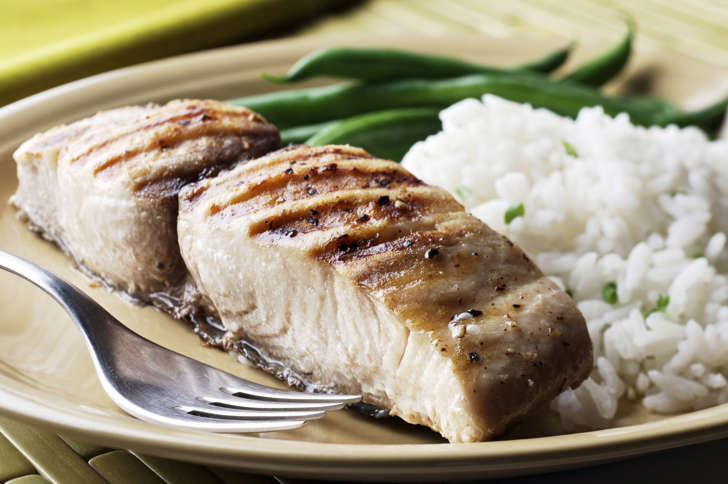 Grilled cutlet (open steak cut) of mahi-mahi (dolphin fish) with rice and green beans on the side