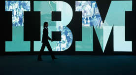 A woman walks past the IBM logo at the CeBIT technology trade fair in Germany.