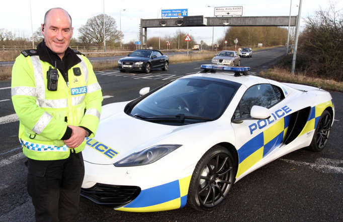 PC Angus Nairn with the McLaren police supercar - Police force loaned 200mph McLaren Spider 12C police car, West Midlands, Britain - 10 Jan 2014